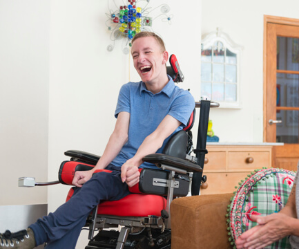 Happy young man in wheelchair.