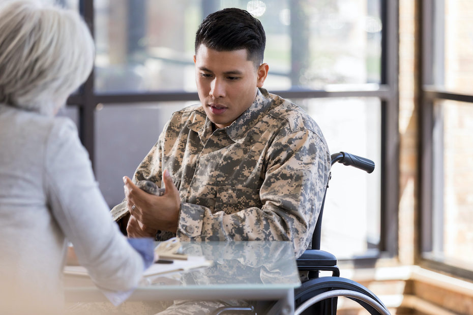 Paraplegic soldier talks with female therapist