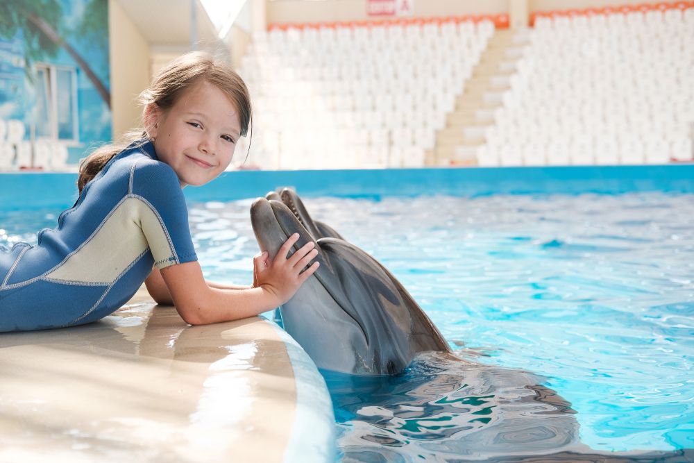 Therapy animals for kids with disabilities, shown here is a child with a dolphin