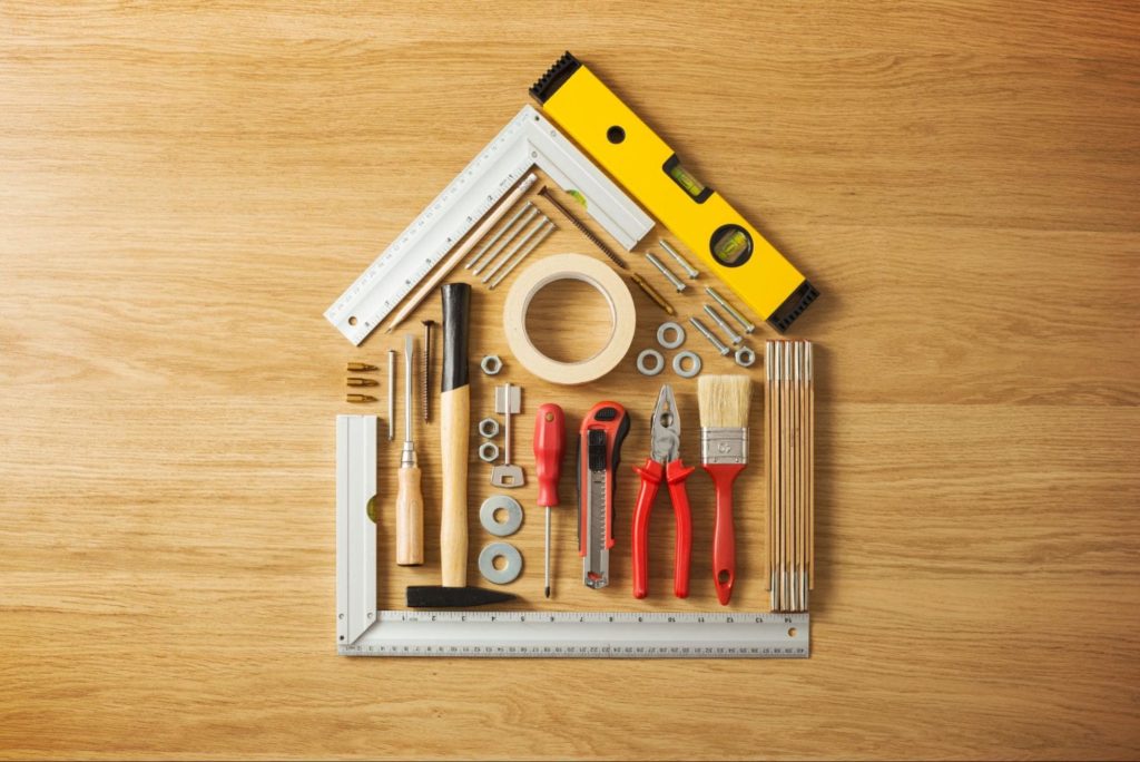 A mix of home tools shaped like a typical house framework