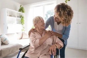 woman comforting older woman in a wheelchair