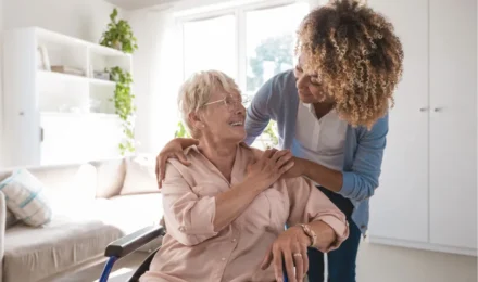 woman comforting older woman in a wheelchair